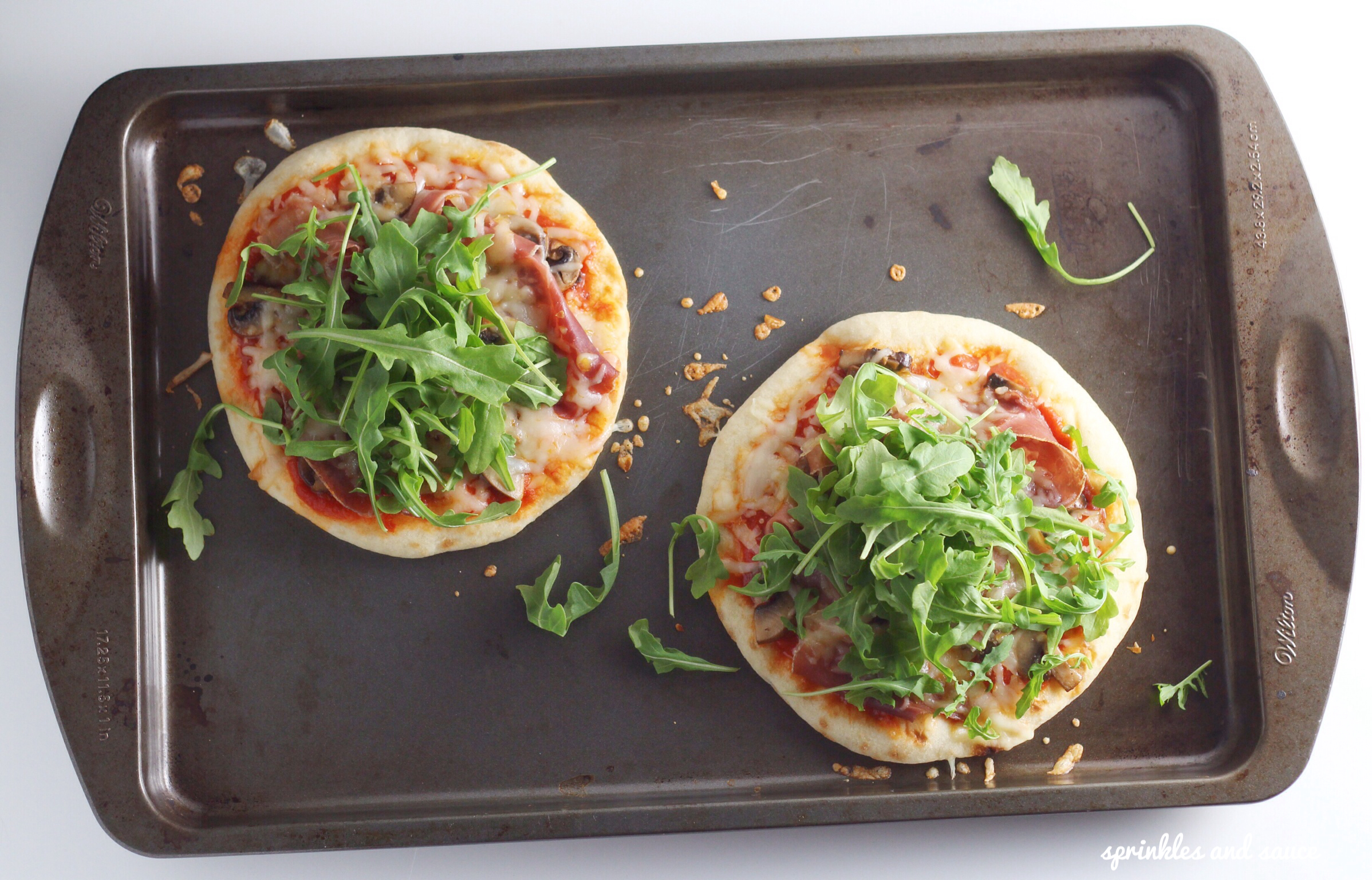 Pita Pizza with Prosciutto, Mushrooms and Arugula - sprinkles and sauce